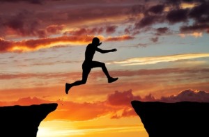 Man jump through the gap on sunset fiery background. Element of design.