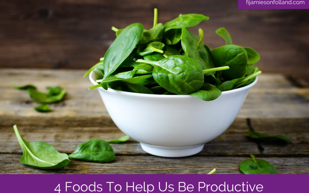 a bowl of spinach placed in the wooden table