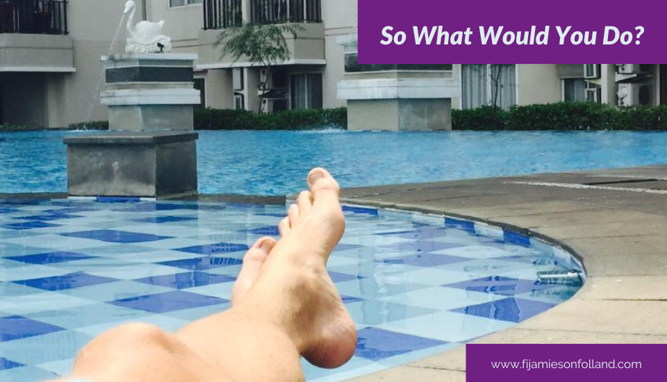 View of a swimming pool with a woman relaxing